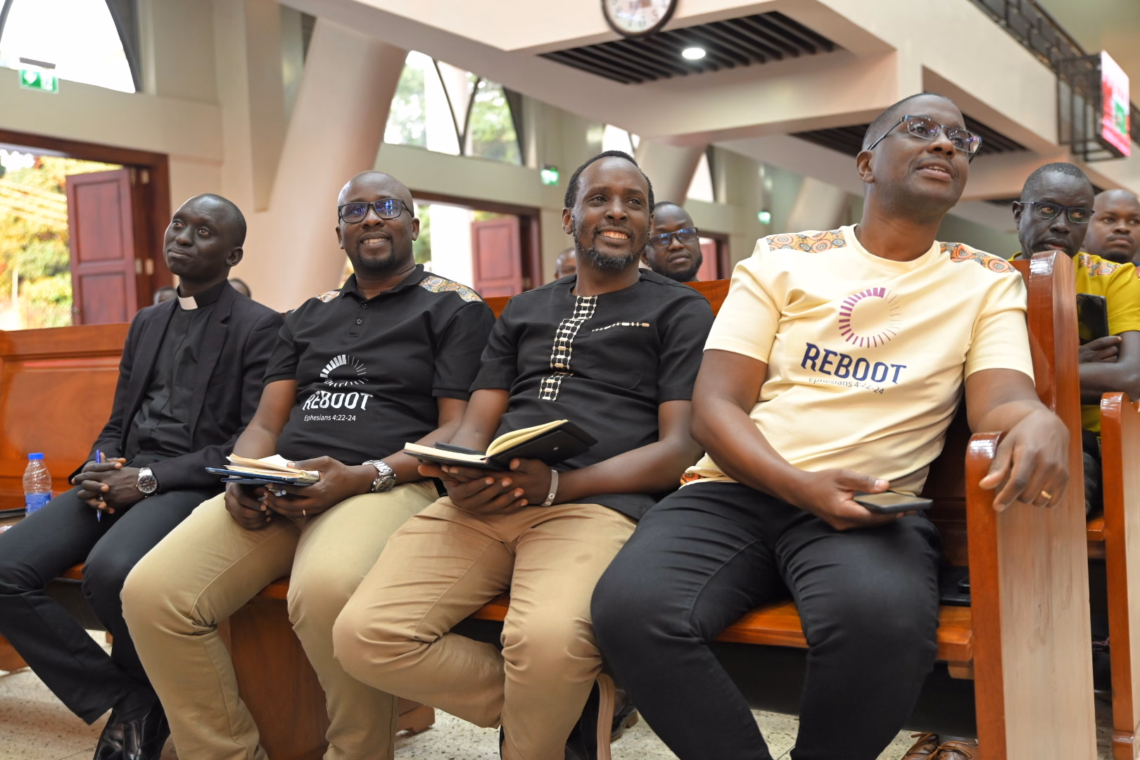Young men sitting together during a conference session