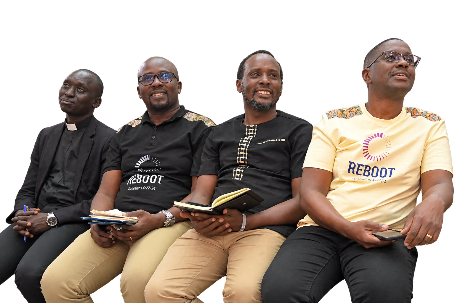 Four men seated together, listening and taking notes