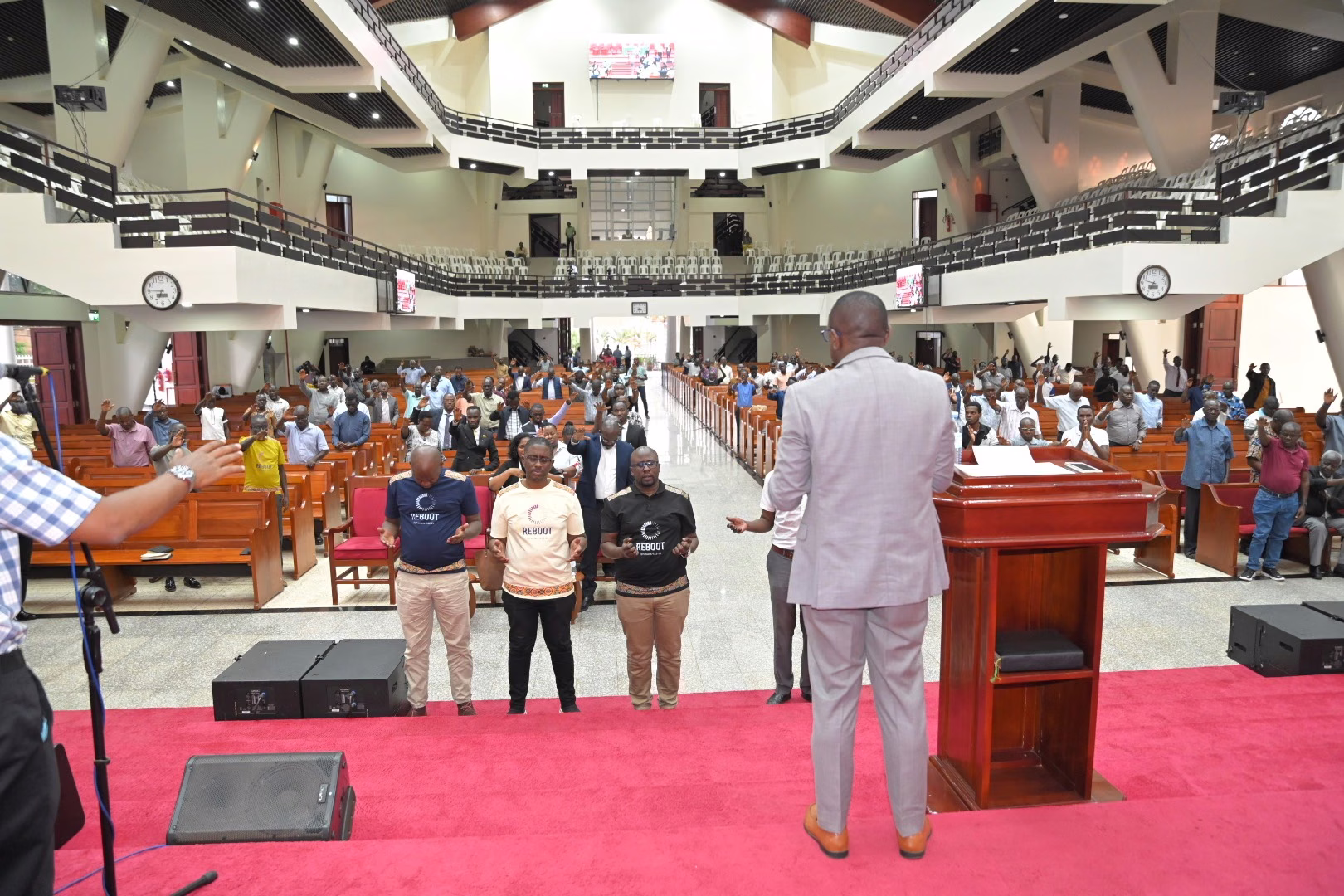 A wide view of men gathered in prayer at All Saints' Cathedral Kampala